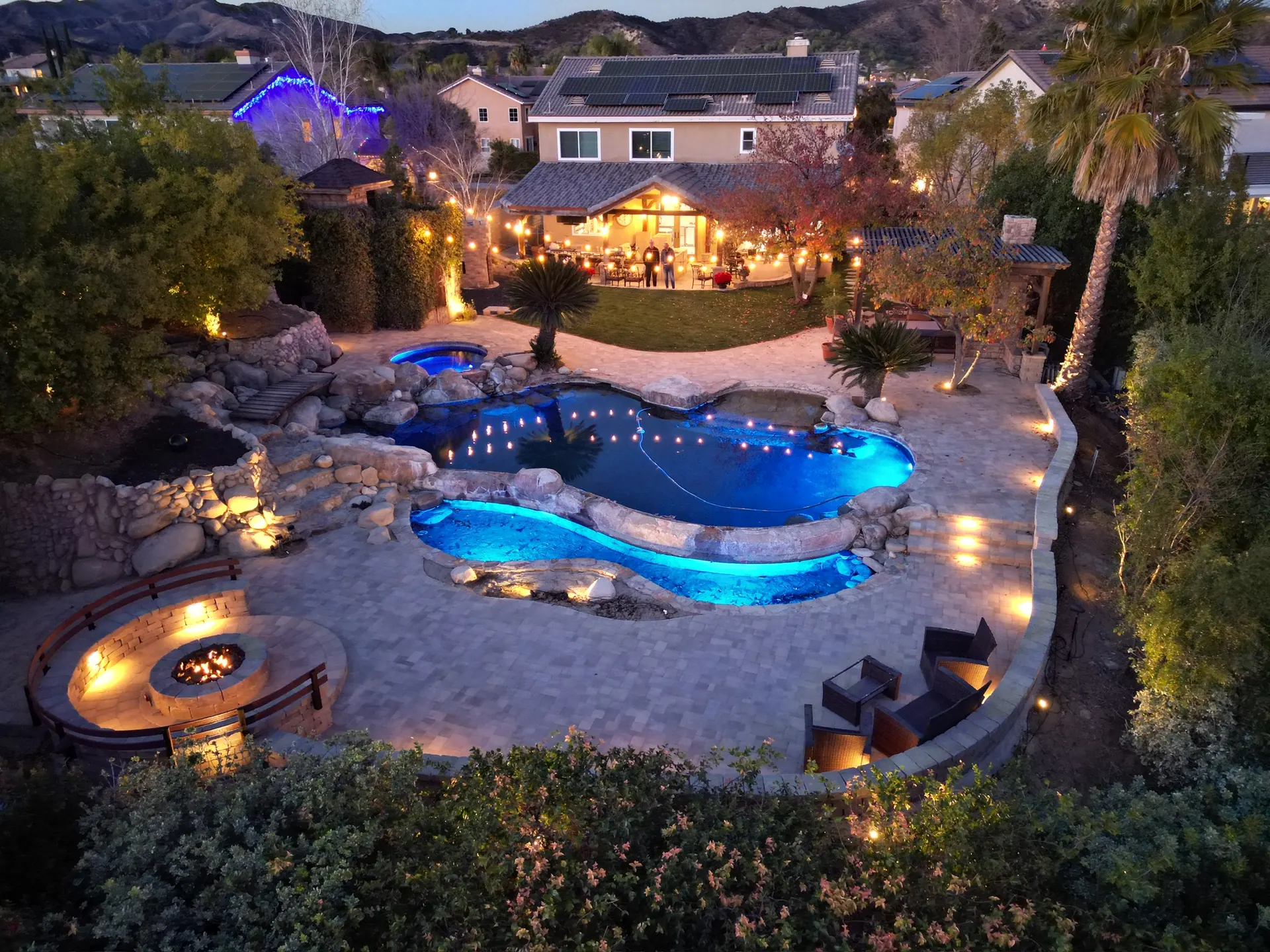 Resort-style backyard with freeform pool and fire pit