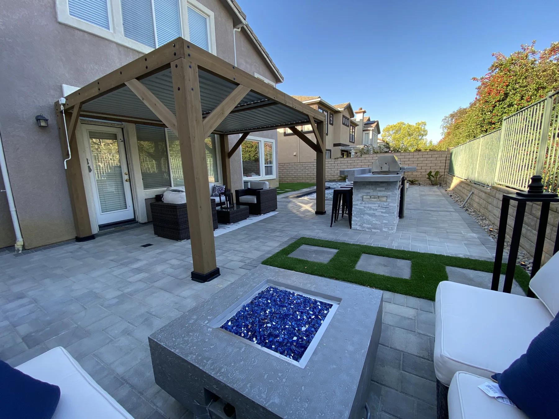 Backyard lounge with fire feature and string lighting