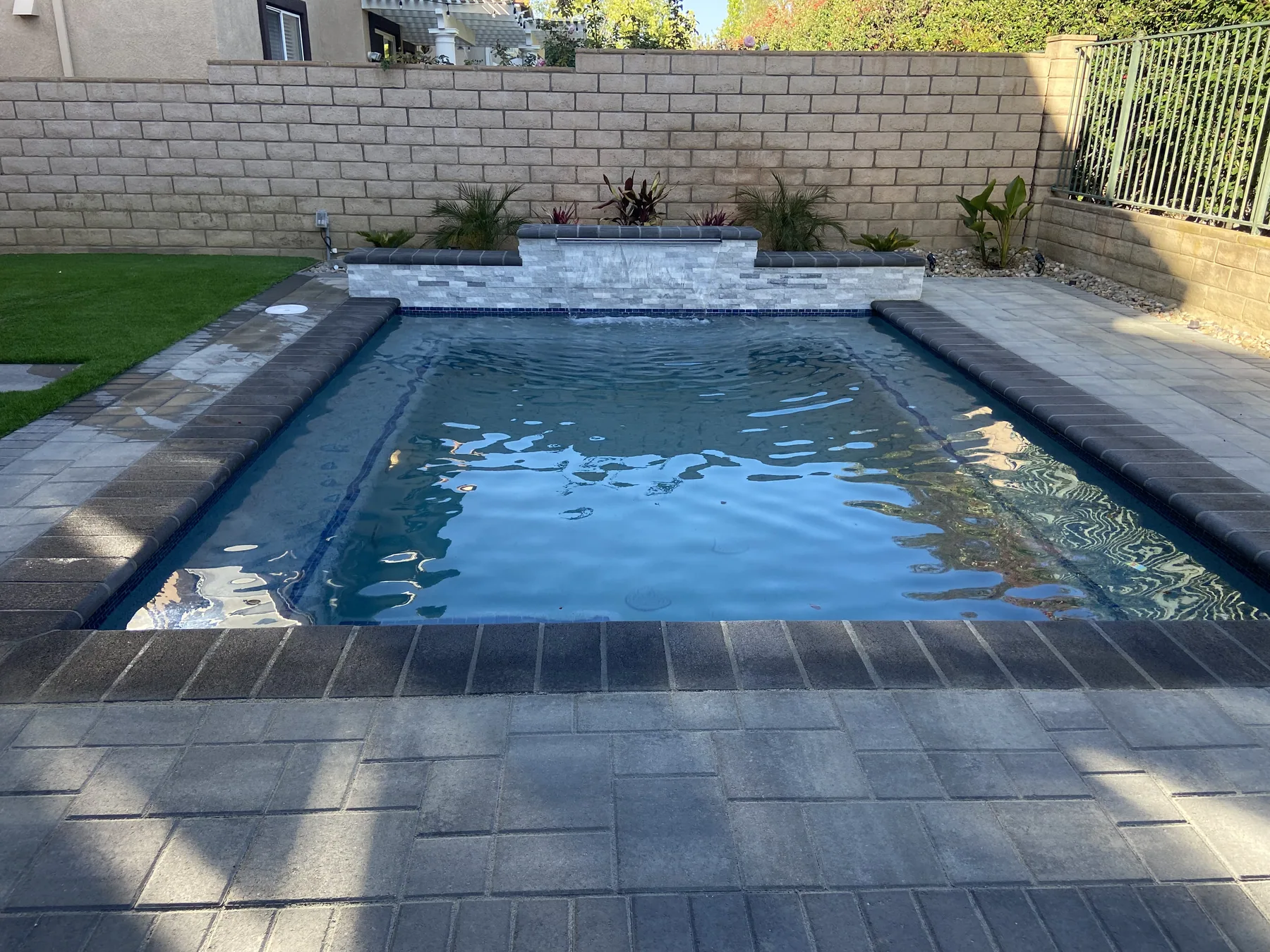 Pool with tile band and paver decking