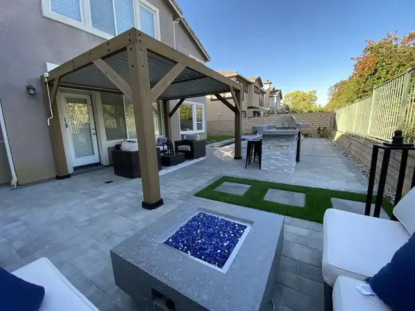 Backyard lounge with fire feature and string lighting