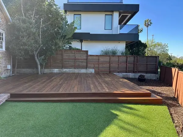 Hardwood deck built level with a turf lawn