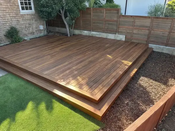 Hardwood deck with stepped edge against a turf lawn