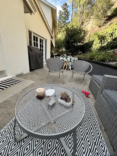 Paver patio with lounge seating and a low retaining wall