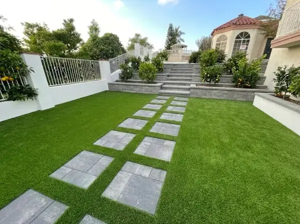 Large paver stepping stones set into a turf lawn