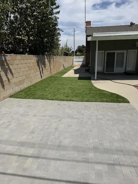 Side yard with turf and a narrow paver path