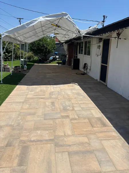 Long paver walkway running beside the house